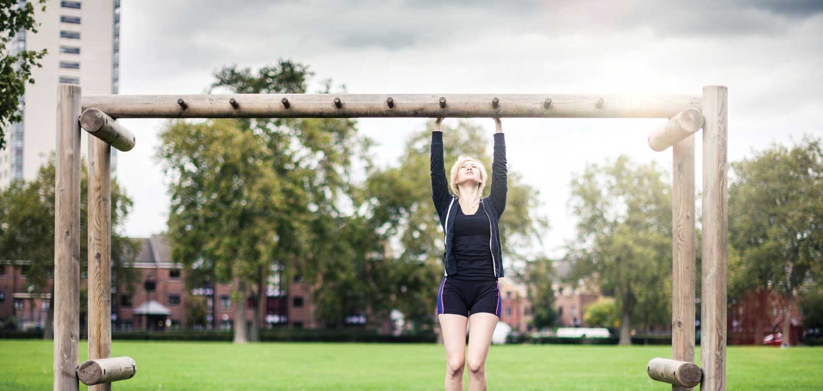 Woman doing Pullup Outside